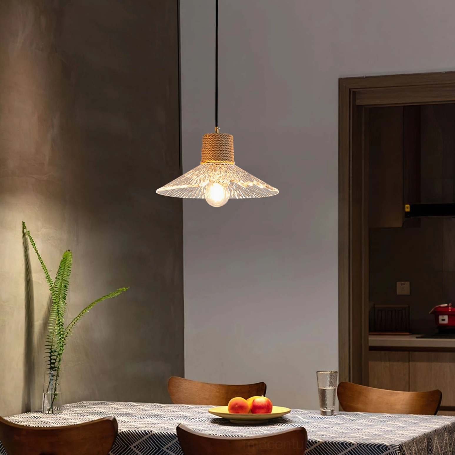 Wide fluted glass hemp rope pendant fixture above dining table with place settings, warm rustic ambiance lighting