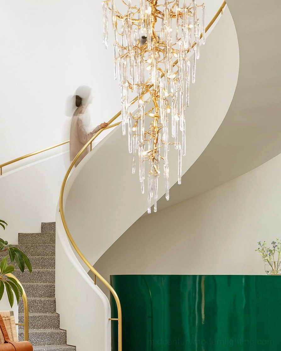 Hand-cast brass branch chandelier showing organic curves and glass drop arrangement detail