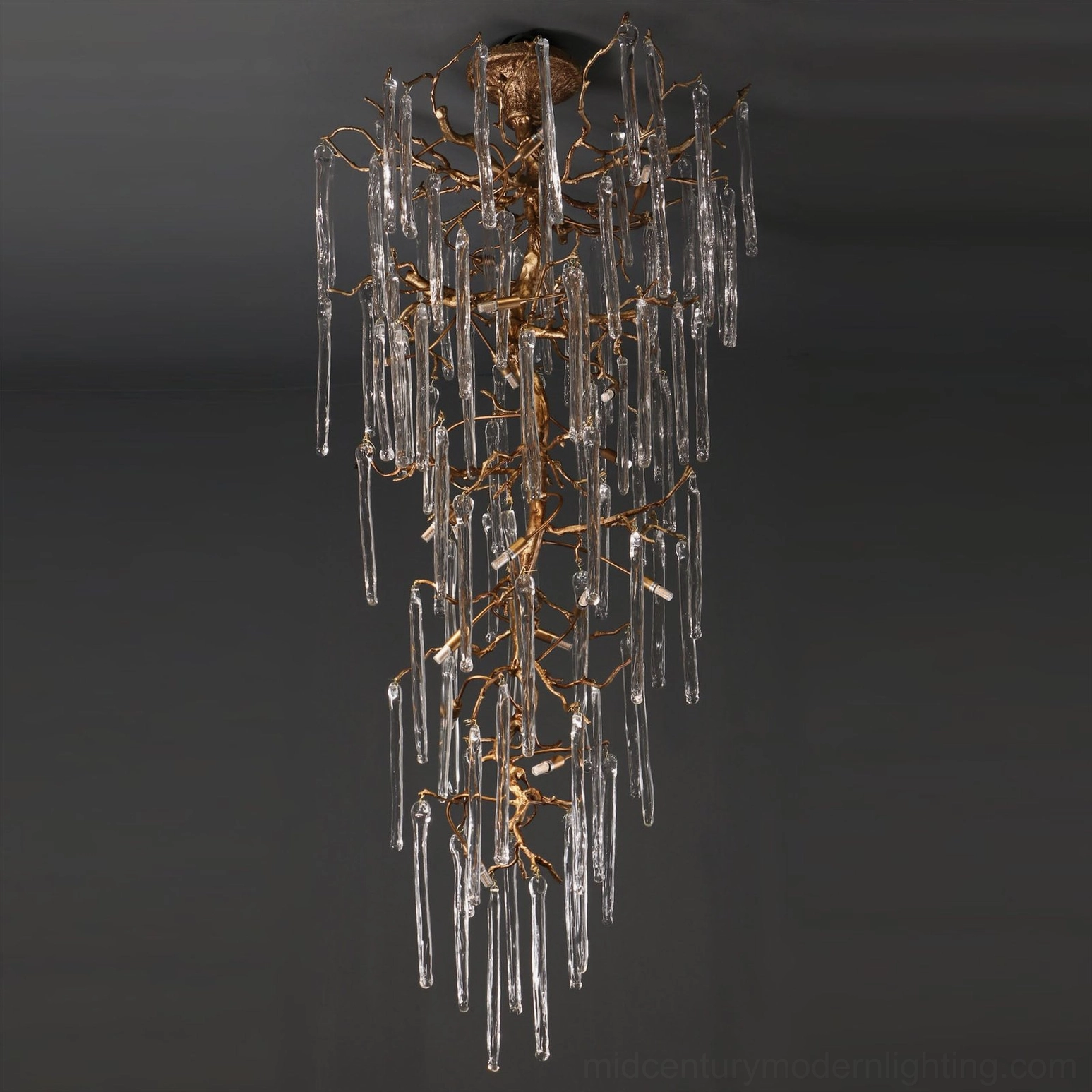 Contemporary glass chandelier with warm antique brass finish, modern sculptural lighting fixture
