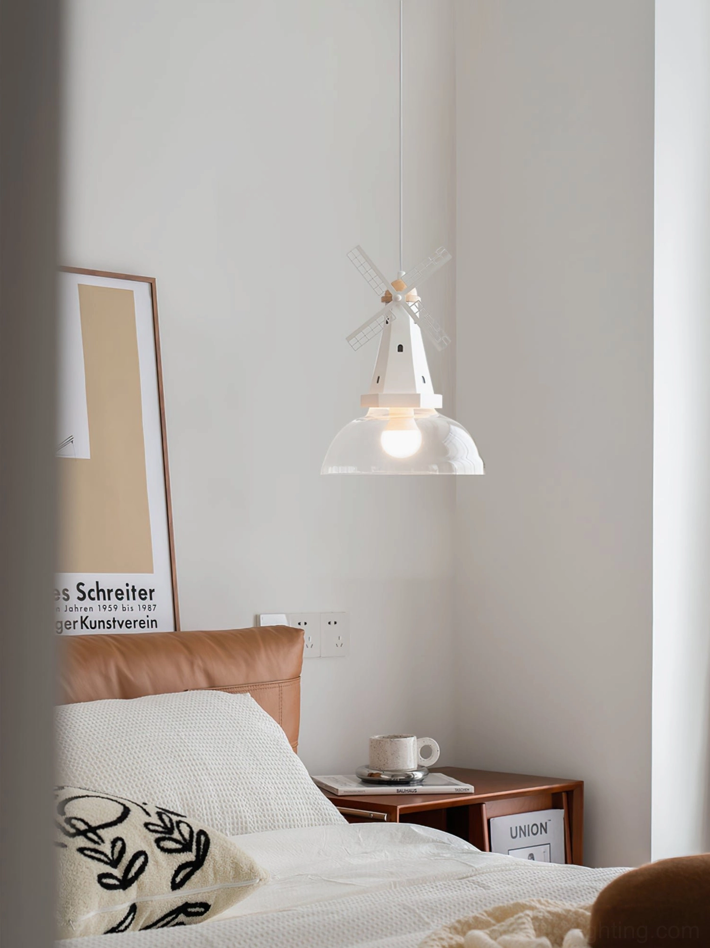 Windmill pendant light hanging in warm wooden bedroom with cozy scandinavian home aesthetic