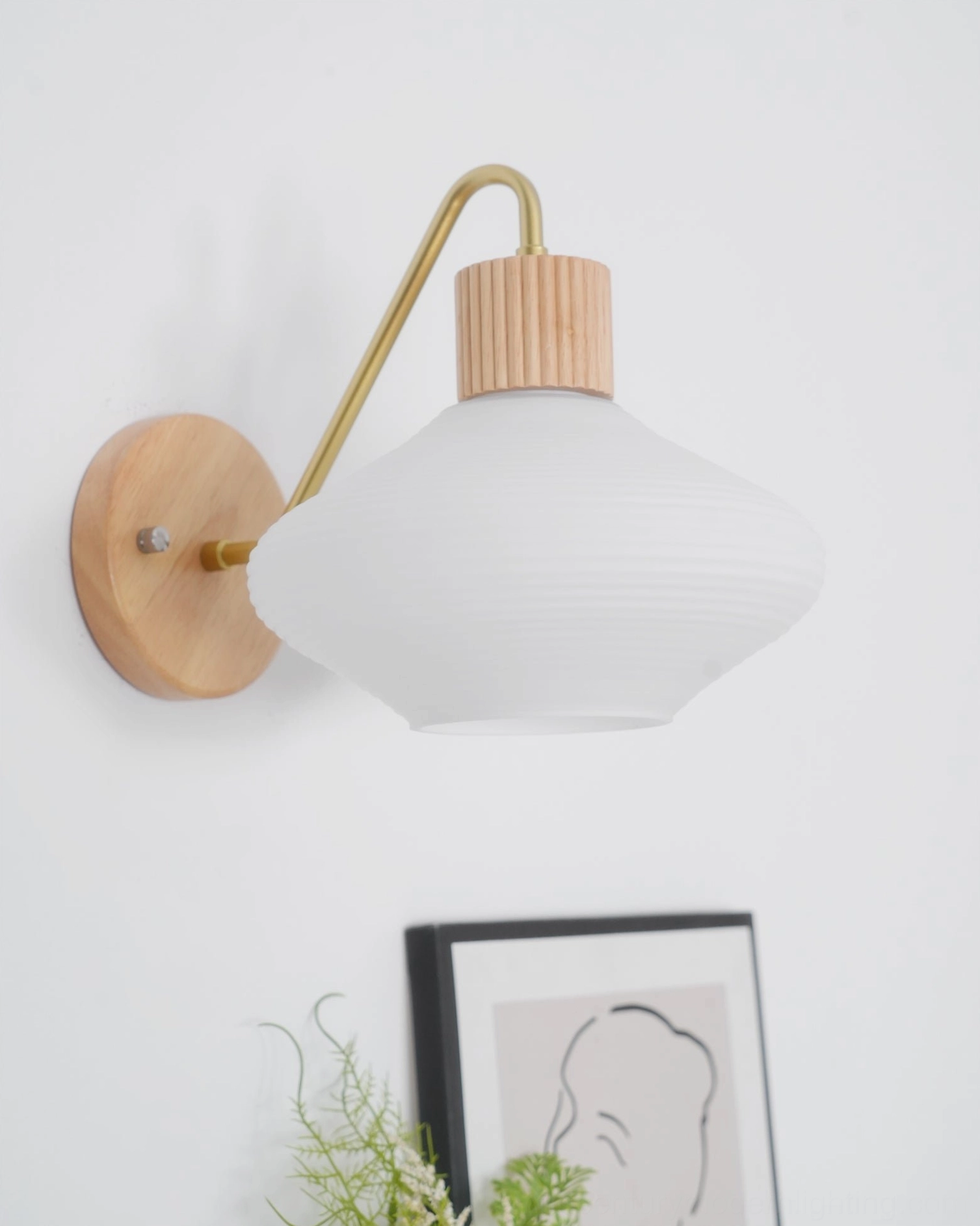 Wohlert mid-century modern wall sconce with curved brass mount
