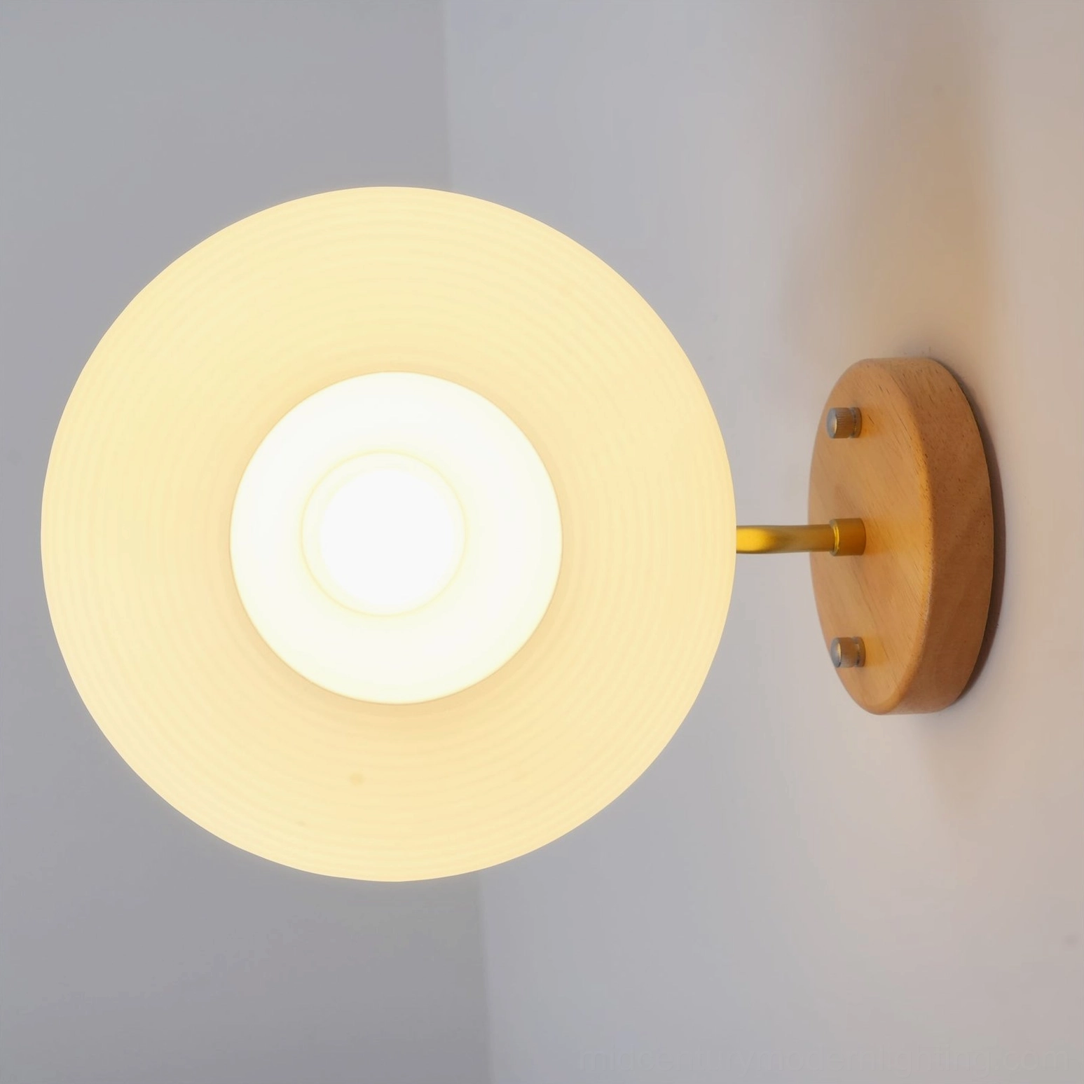 Wohlert disc-shaped frosted glass shade installed in corner wall top-down view