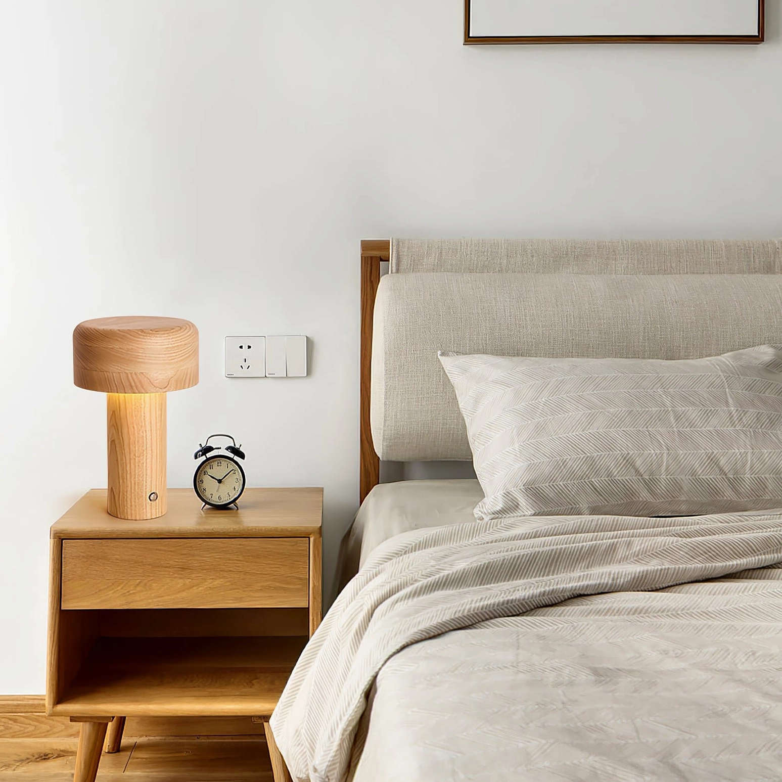 Wooden mushroom lamp on bedroom nightstand with alarm clock and warm ambient lighting