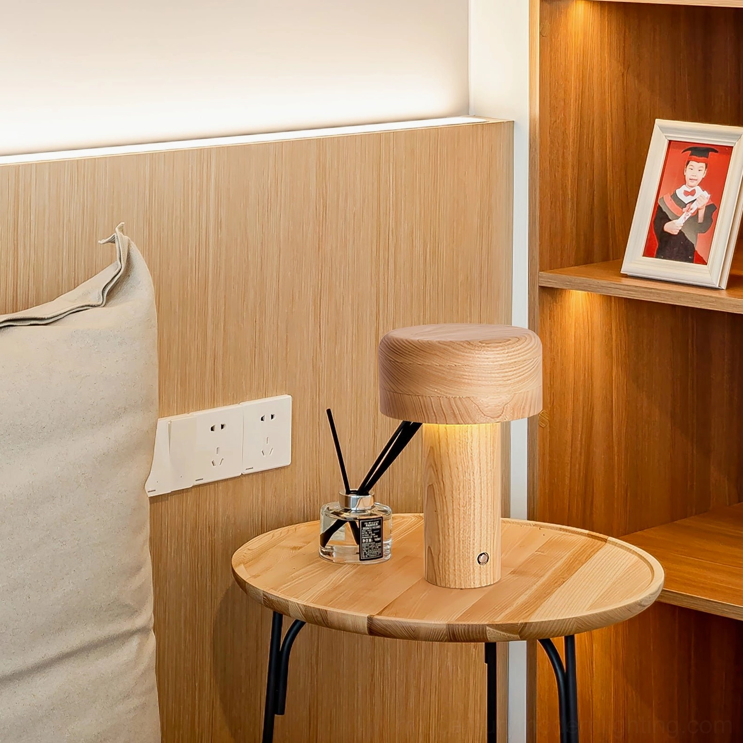 Natural wood mushroom lamp on home office desk with wooden shelf and stationery decoration