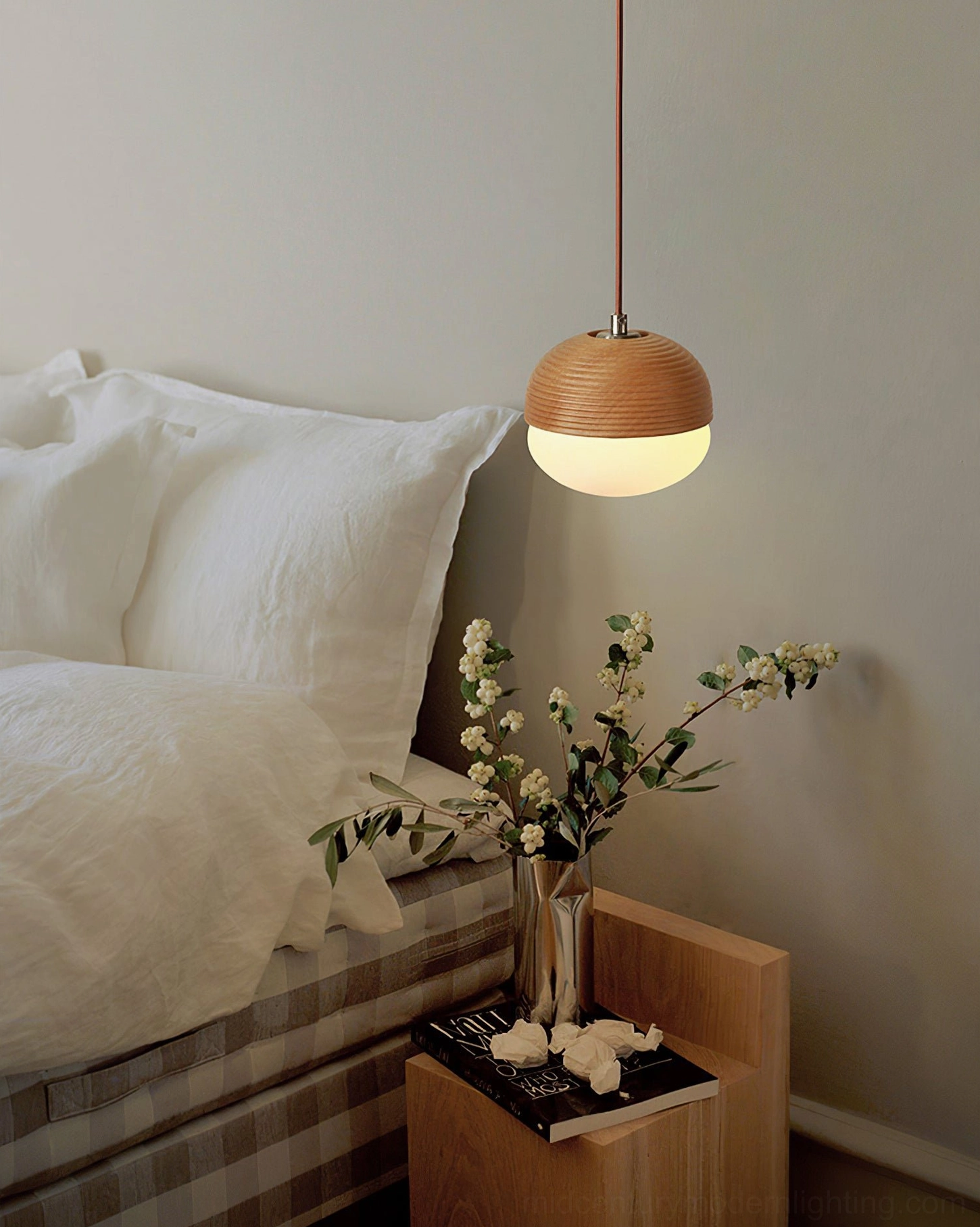 Wooden pendant light beside bed in cozy minimalist bedroom, warm glow over nightstand area