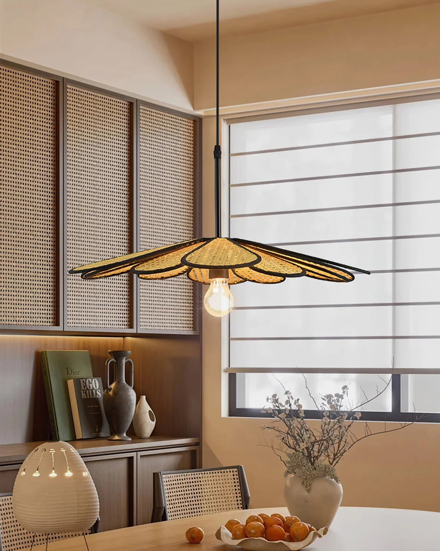 Artisan-woven flower pendant lamp above rustic dining table with shuttered window and vintage home decor styling