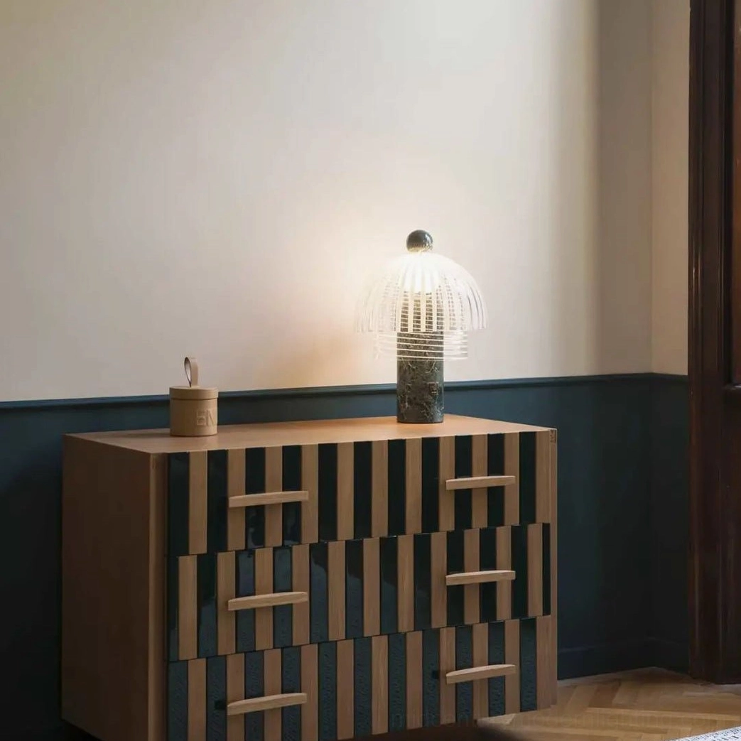 Green marble frosted glass table lamp in bedroom corner on vintage checkered dresser creating warm light