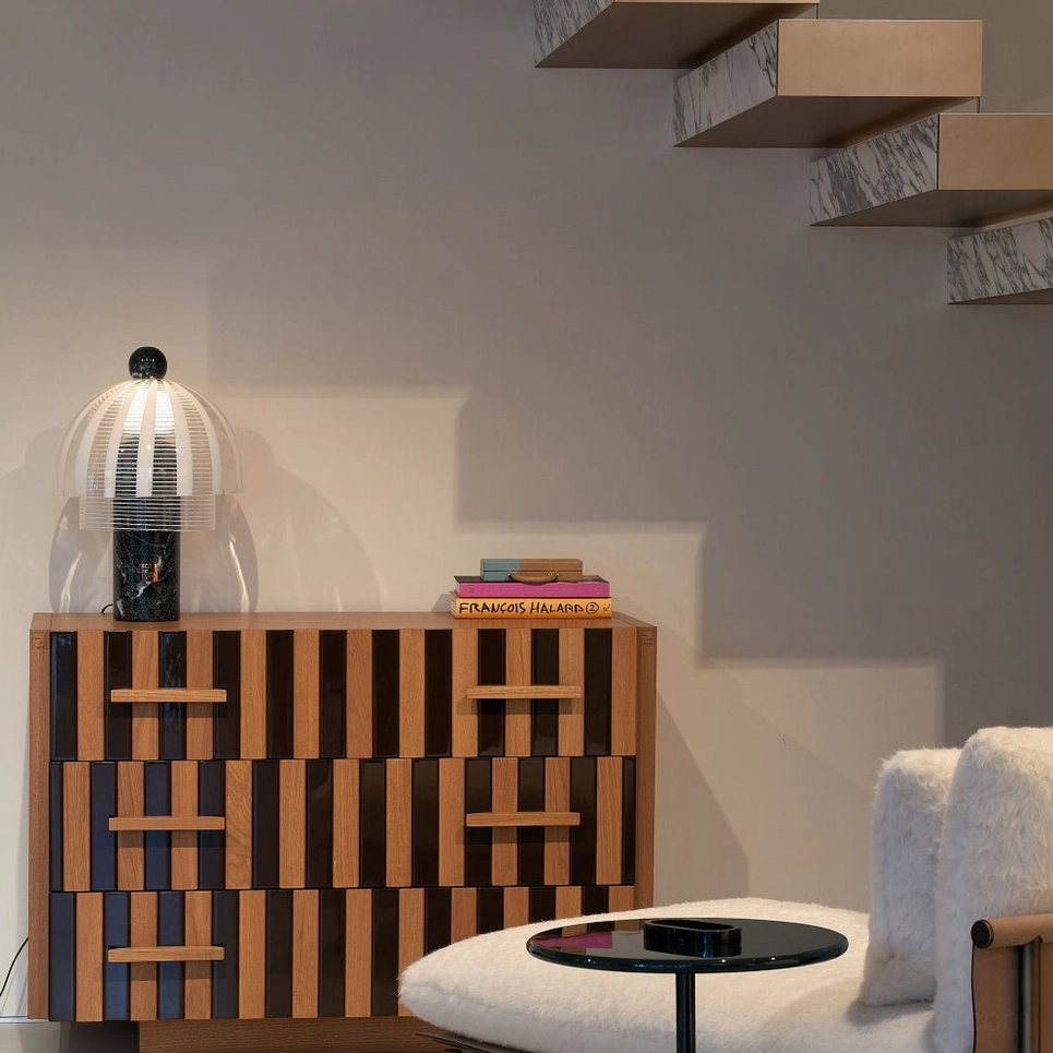 Yasuke modern table lamp in living room on geometric patterned cabinet with staircase backdrop