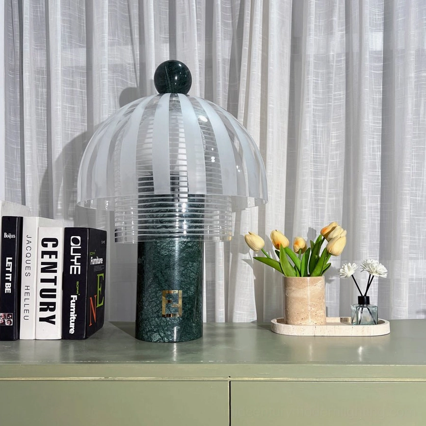 Yasuke table lamp on green sideboard with decorative books and flowers, soft side-front view