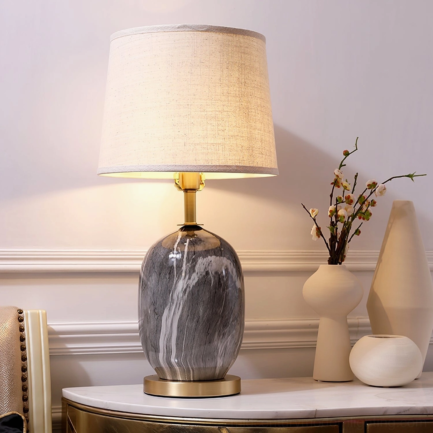 Grey marble Yopal table lamp on console table with minimalist ceramic vases, warm modern luxury lighting