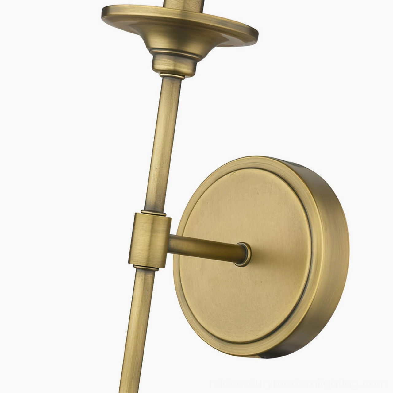 Close-up detail of antique brass wall sconce mounting hardware and pivot joint