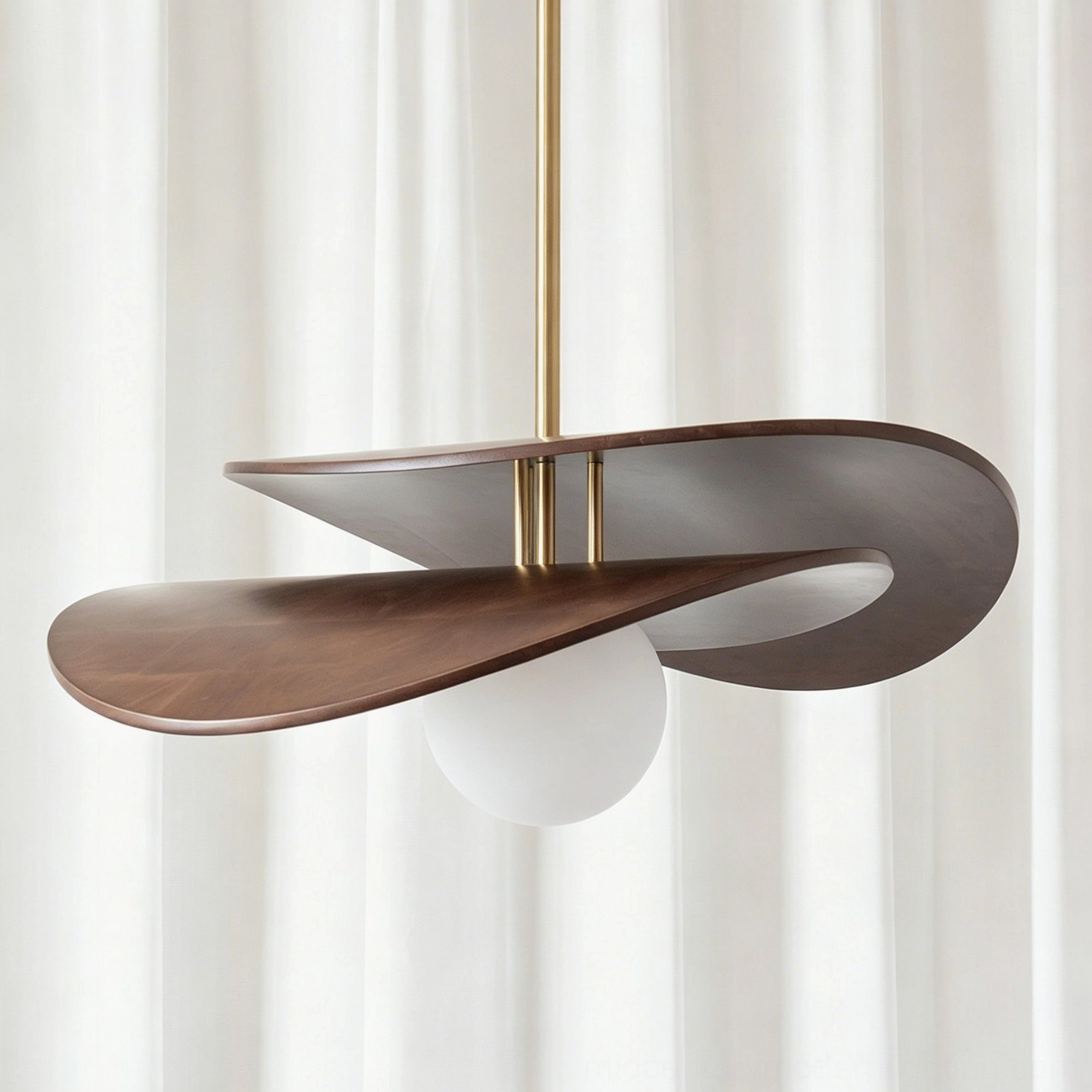 Close-up detail of Zane pendant light showing dark walnut wood grain, brass stem, and frosted opal glass diffuser