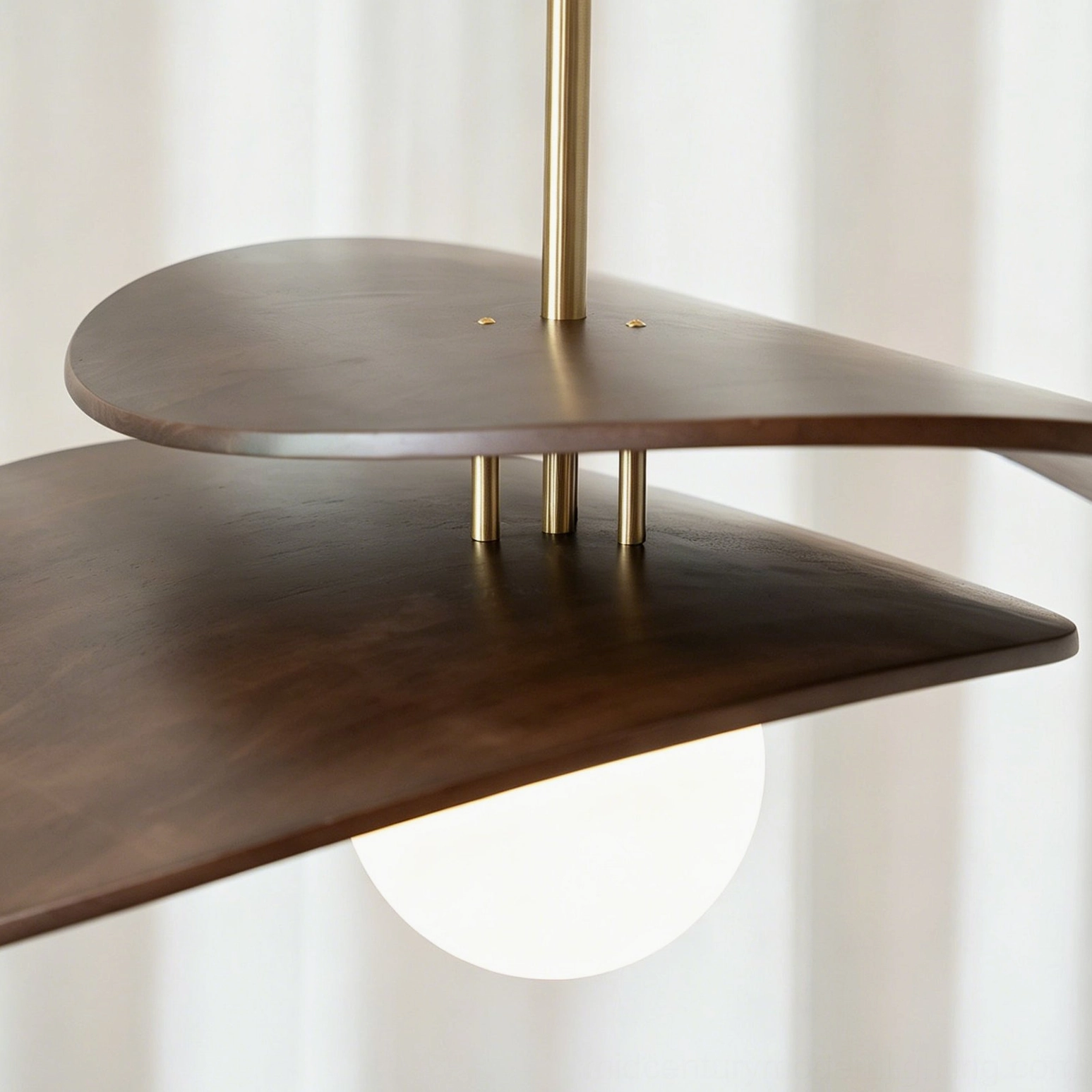 Zane mid-century modern pendant light artistic product shot showing sculptural wooden curves and brass hardware details