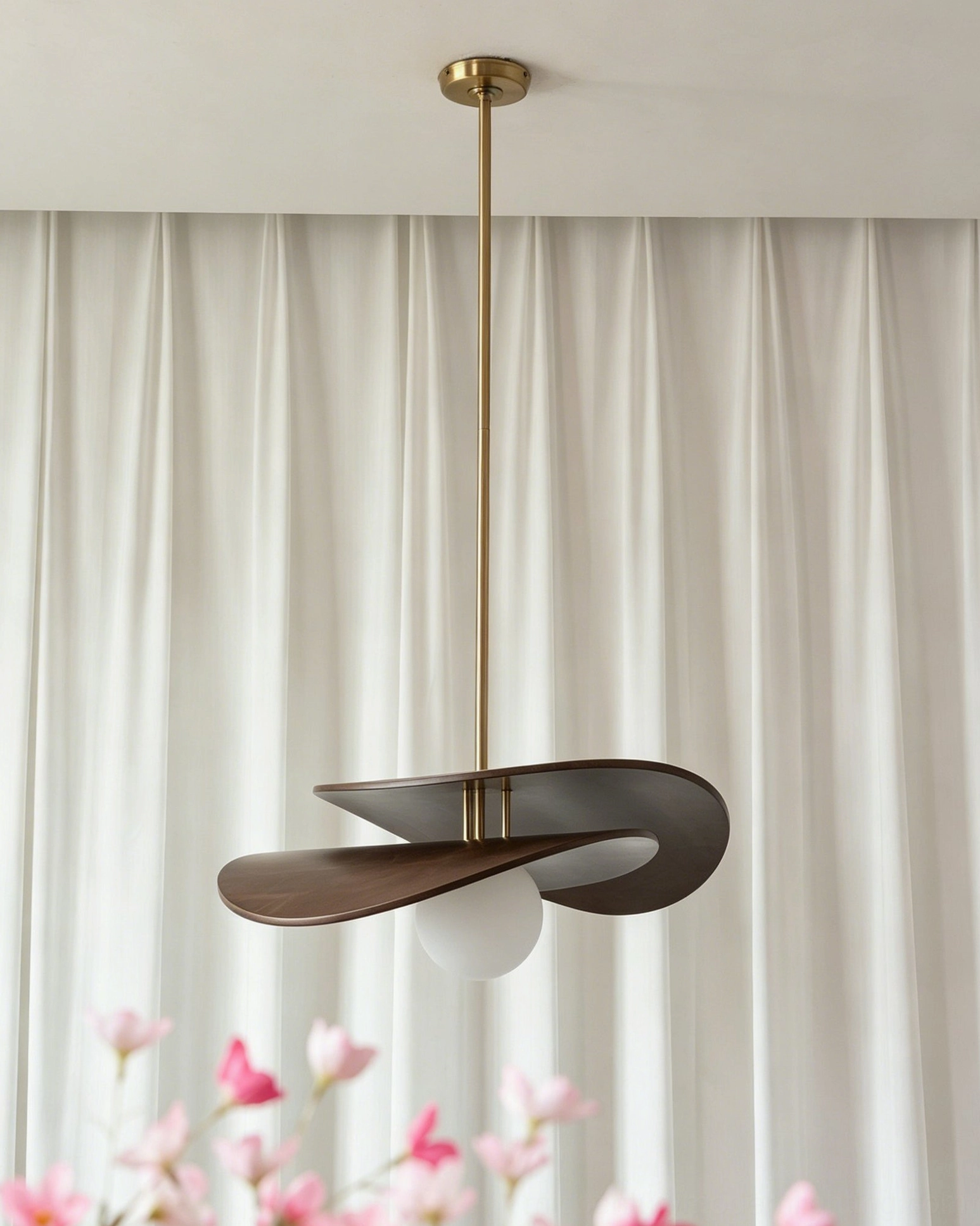 Zane walnut pendant light front three-quarter view highlighting twisted wood structure and hand-blown glass diffuser detail
