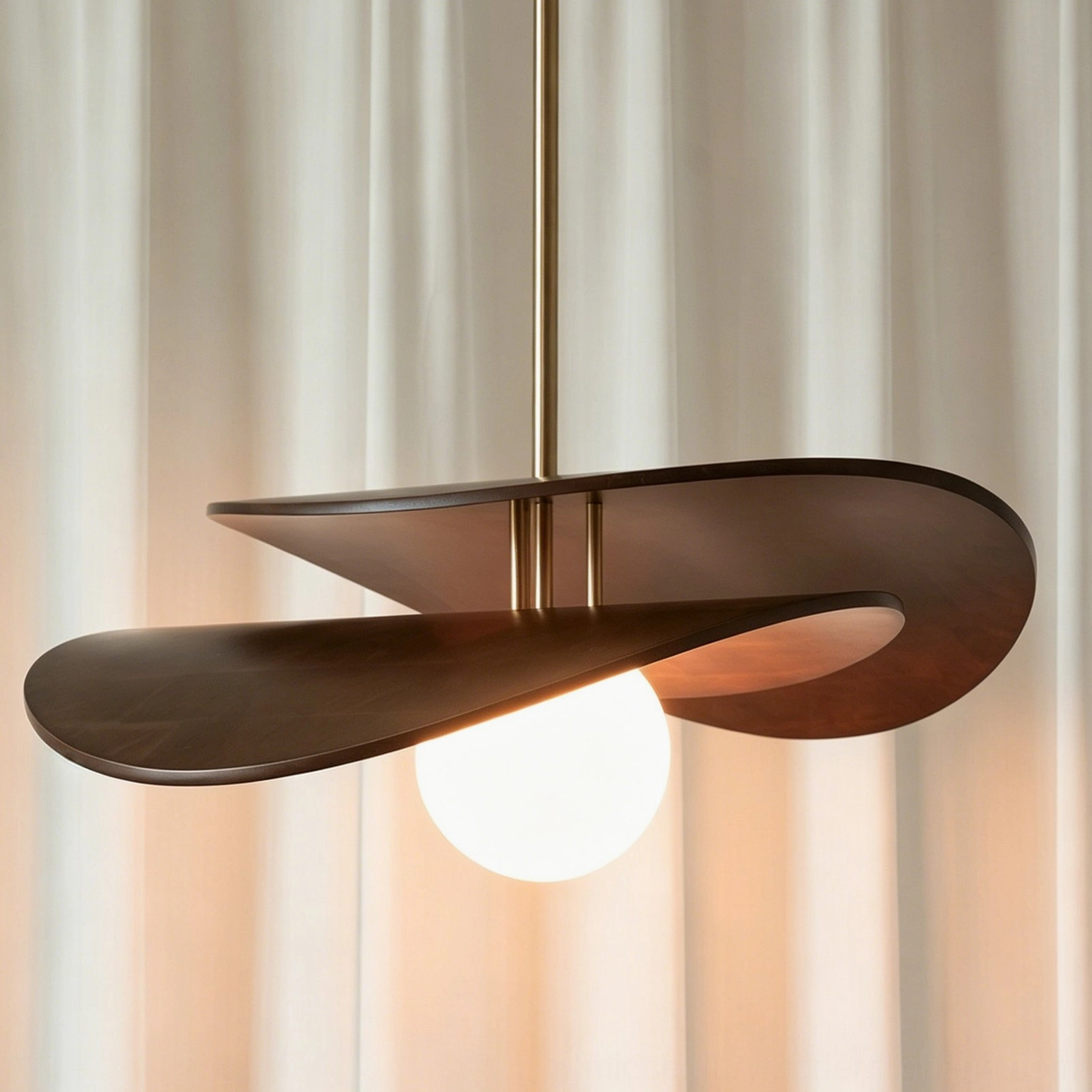 Side oblique close view of Zane pendant light featuring smooth dark walnut finish and bright frosted opal lamp diffuser