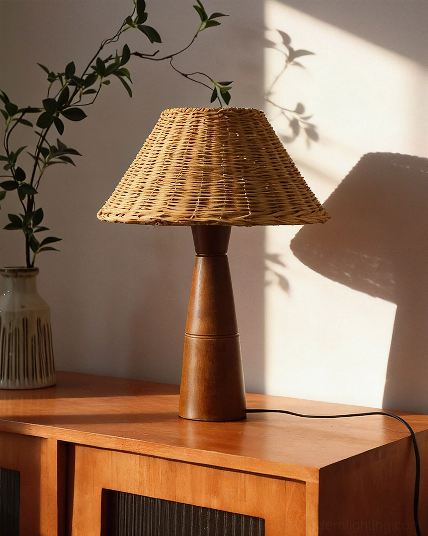 Zaya table lamp with warm LED light glowing through rattan shade, ambient lighting demonstration