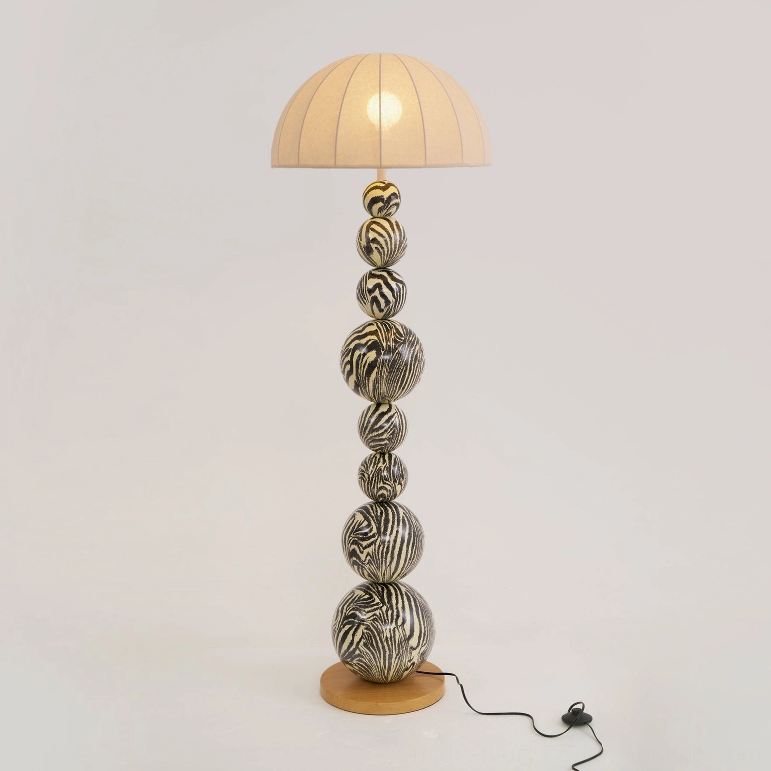 Zebra floor lamp with wooden sphere base and water transfer printed black and white stripes close-up detail