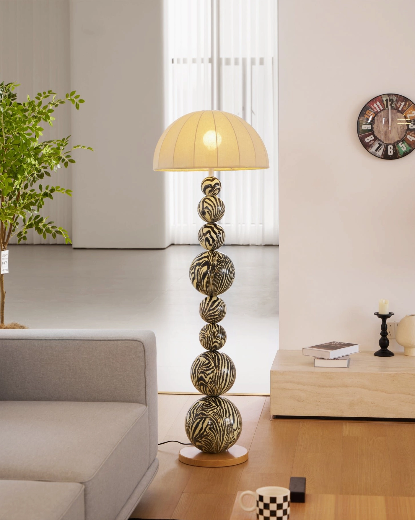 Sculptural zebra floor lamp in minimalist living room with low table and wall clock, front three-quarter view