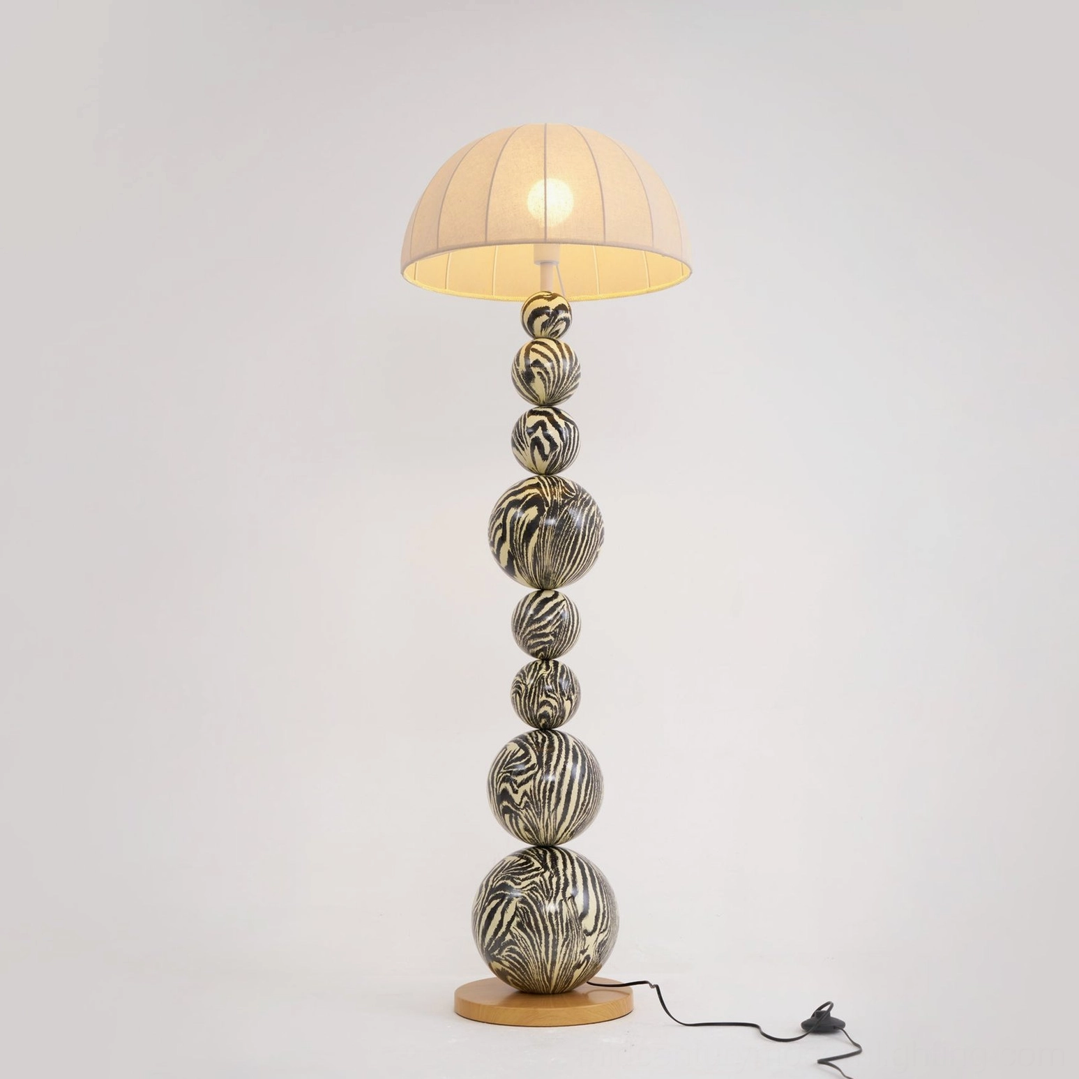 Zebra modern floor lamp showing pleated cream fabric shade and natural wood color finish