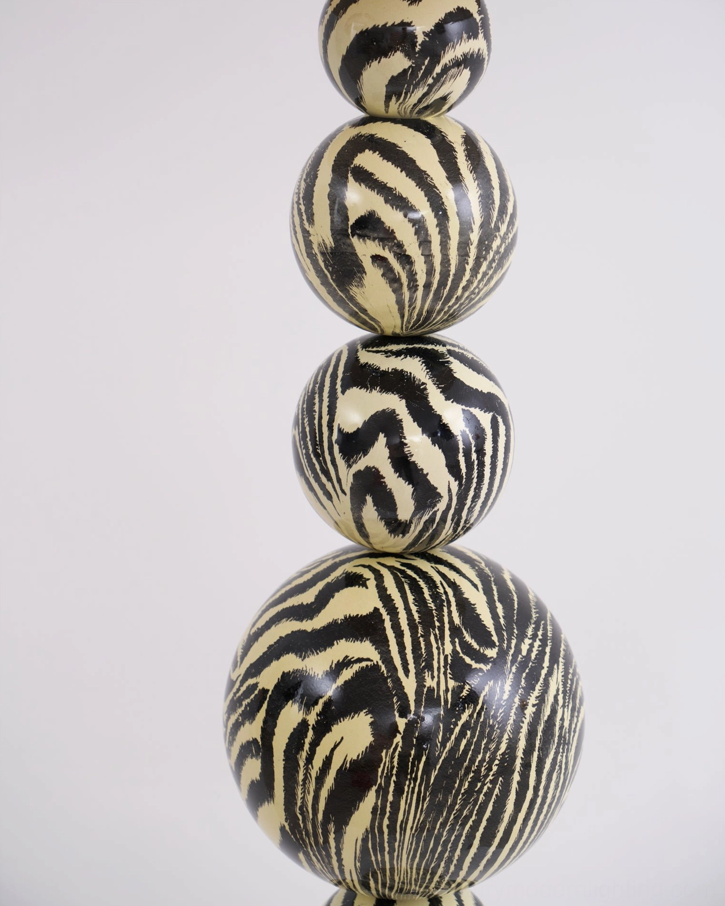 Artistic zebra floor lamp with stacked wooden sphere construction and water transfer printed pattern