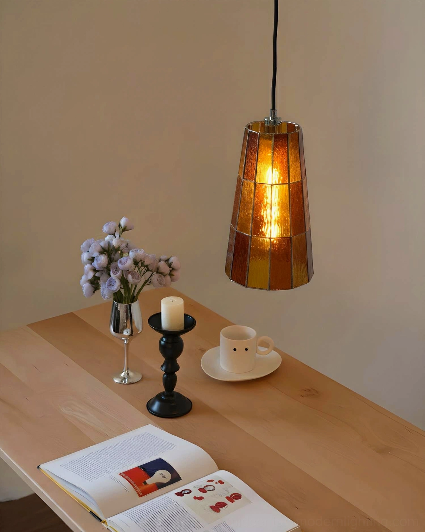 Zola amber glass pendant fixture casting warm light over cozy home dining nook, overhead view