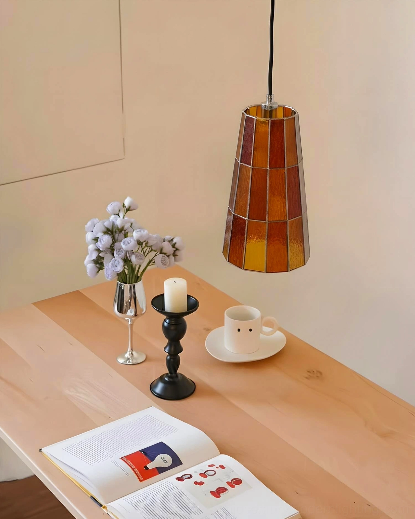 Zola geometric glass pendant lamp side angle view in home dining area with amber tapered shade